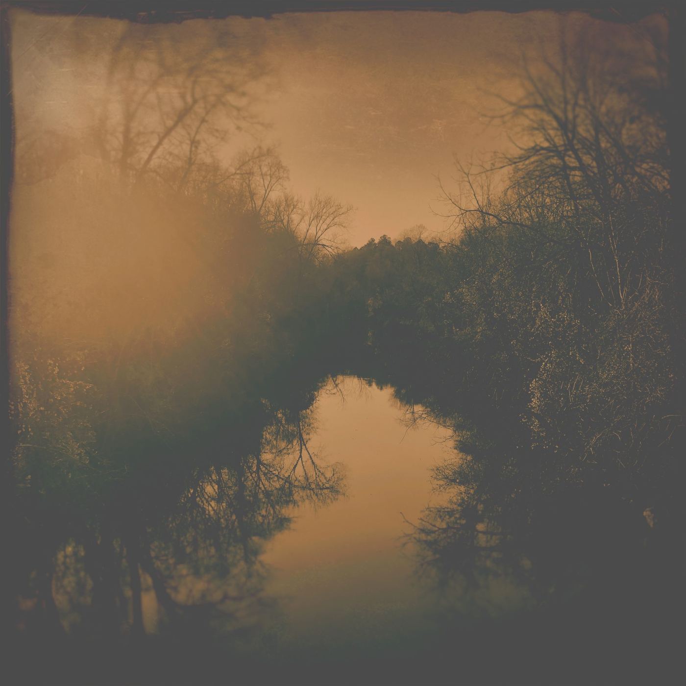 The misty river in amber light