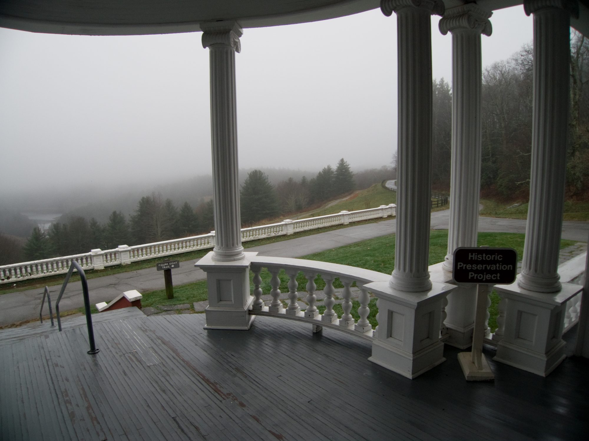 A porch’s columns, the valley in fog beyond